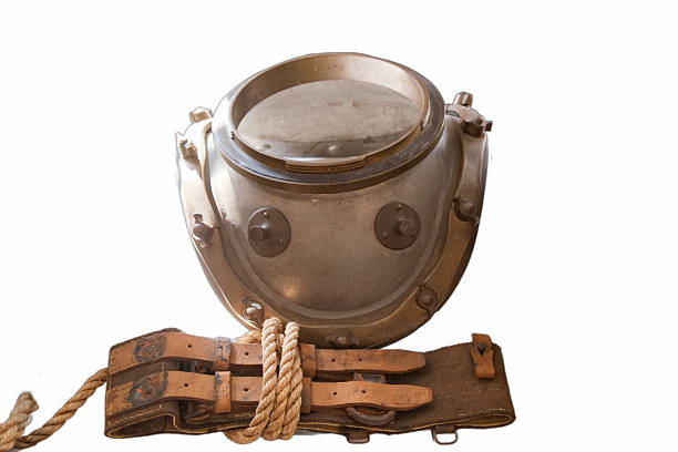A vintage deep sea diving helmet sits prominently on a white background, showcasing its metal design and attached straps. The helmet represents maritime exploration and underwater adventures.