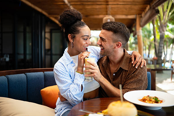 istock Romantic dining moments, a smiling man enjoys a special meal while holding hands with his partner 2240134350