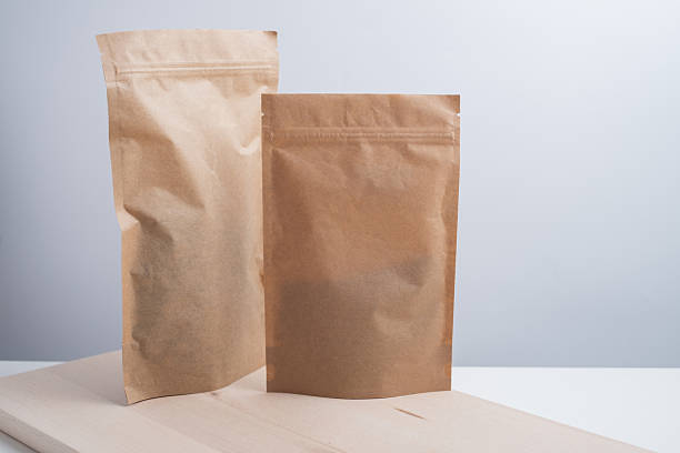 istock Craft packaging for tea, coffee, snacks, and cosmetics on a light background. Branding and product packaging mockup. Close-up of the packaging. Product for sale. Blank mockup. 2240134629