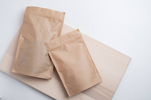istock Craft packaging for tea, coffee, snacks, and cosmetics on a light background. Branding and product packaging mockup. Close-up of the packaging. Product for sale. Blank mockup. 2240134644