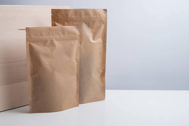 istock Craft packaging for tea, coffee, snacks, and cosmetics on a light background. Branding and product packaging mockup. Close-up of the packaging. Product for sale. Blank mockup. 2240134653