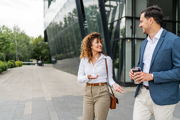 istock Business colleagues walking and talking during coffee break 2240137193