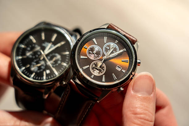 istock Daylight saving time change. A woman holding two classic quartz watches and changing the time. Sunny glow. 2240137509