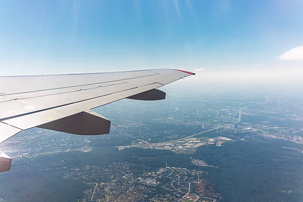 istock View from the airplane window at a beautiful cloudy sky and the airplane wing 2240137616