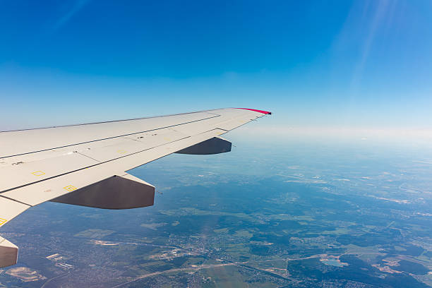 istock View from the airplane window at a beautiful blue clear sky and the airplane wing 2240137633