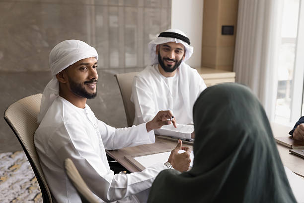 istock Arabic businesspeople lead talk seated around conference table 2240139930