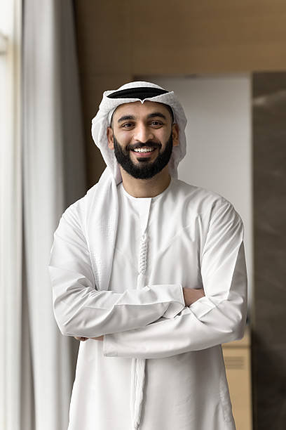 istock Entrepreneur dressed in traditional Arabic white kandora posing at workplace 2240143039