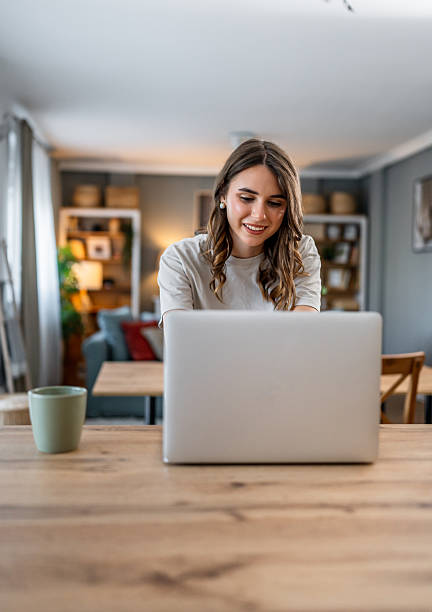 istock Young woman confidently working on laptop at home 2240144184