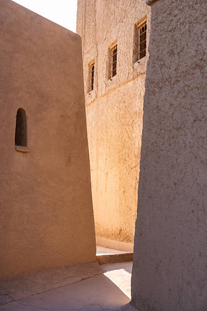 istock Oman traditional mud brick buildings creating a sunlit alley 2240147013