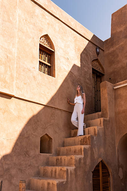 istock Woman traveling oman, exploring ancient mud brick architecture 2240147581