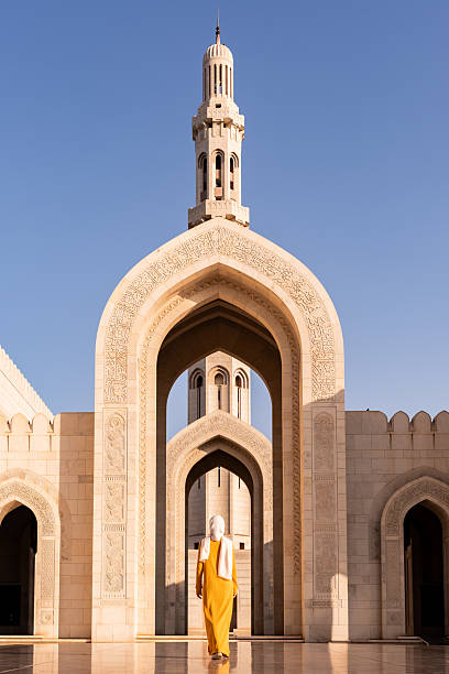 istock Woman walking through arches in sultan qaboos grand mosque, oman 2240148010