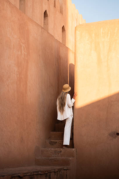 istock Woman exploring ancient omani fort architecture 2240148059