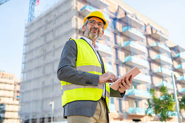 istock Mature adult man inspecting construction site with tablet 2240148355