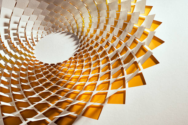 Geometric paper artwork featuring a diamond-shaped mandala cutout with vibrant yellow tones. This still life showcases intricate craftsmanship, precise layering, and a dynamic play of light and shadow for a mesmerizing abstract visual.
