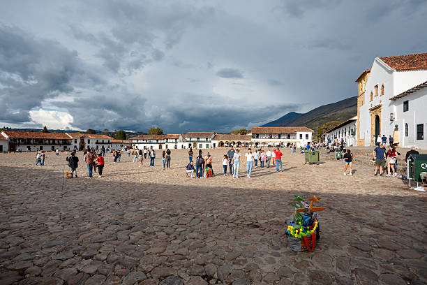 Villa de Leyva, Boyaca, Colombia - November 19 2023: Locals and visitors gather in the vast cobblestone Plaza Mayor of the historic town of Villa de Leyva.
