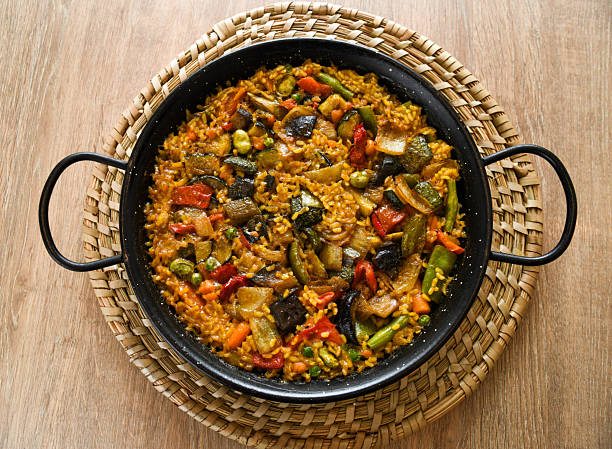 Original paella at El Palmar, Valencia, home of the spanish paella, vegetarian, with vegetables, on table at restaurant