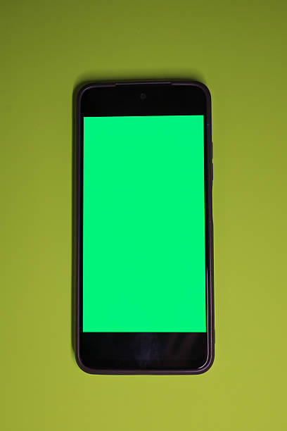istock This vertical minimalistic shot showcases a smartphone with a bright green chromakey screen, centrally positioned on a lime or chartreuse background. 2240155503