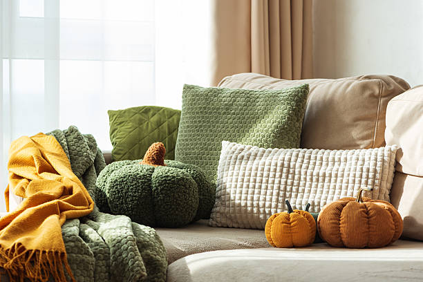 istock Autumn Sofa Styling with Textured Pillows, Fabric Pumpkins, and Cozy Blankets 2240161825