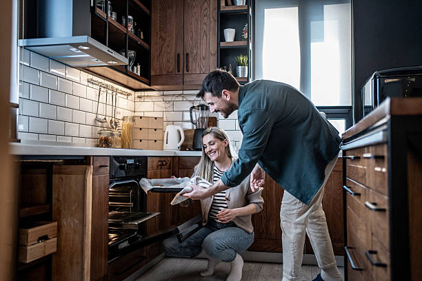 istock Happy couple baking with oven in modern kitchen 2240162413