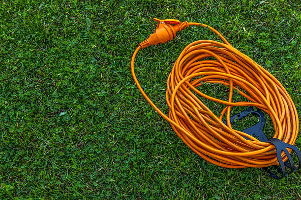 istock Electric extension cord on grass in garden symbolizing connection and harmony 2240163148