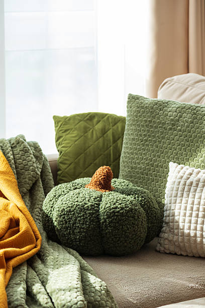 istock Autumn Sofa Styling with Textured Pillows, Fabric Pumpkins, and Cozy Blankets 2240163410