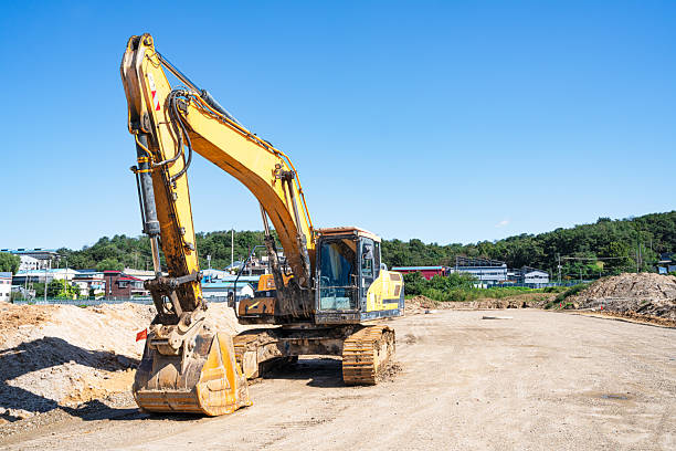 istock Wide construction site with exposed soil, gravel paths, and surrounding mountains in the background, showing early land preparation work under daylight with visible earth layers and groundwork progress. 2240165233