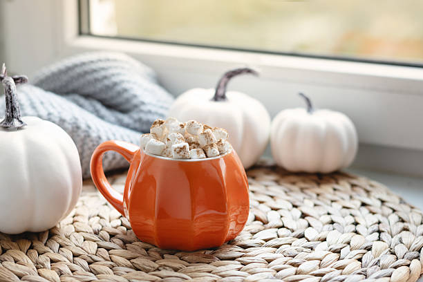 Autumn warming chocolate or coffee on windowsill. Autumn beverage