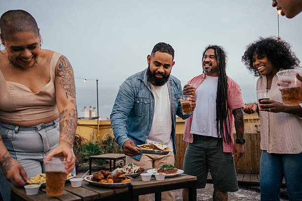 istock Friends socializing with each other, eating snacks 2240167442