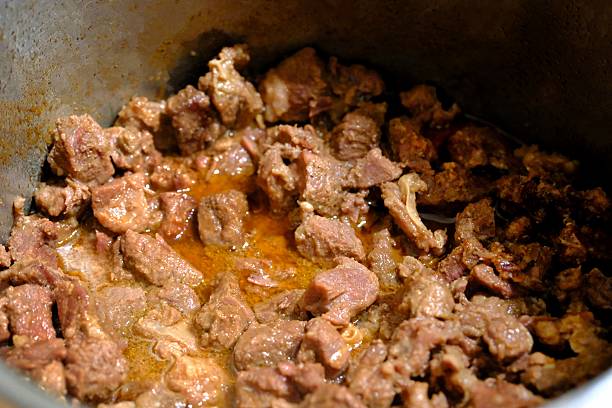 istock Close-up view of roasted boiled meat cooked in a pot. 2240170149