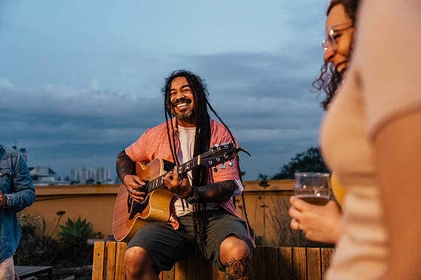 istock Man playing guitar for friends at happy hour 2240171291