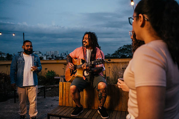 istock Man playing guitar for friends at happy hour 2240171293