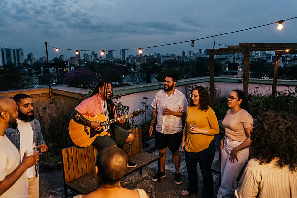 istock Man playing guitar for friends at happy hour 2240171297