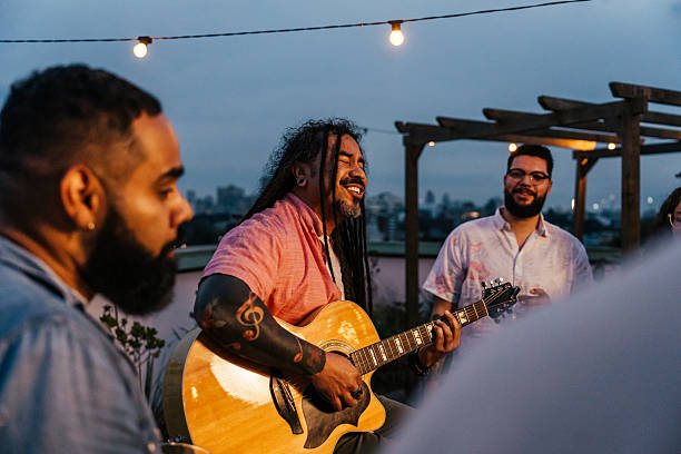 istock Man playing guitar for friends at happy hour 2240171317