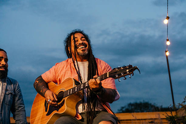 istock Man playing guitar for friends at happy hour 2240171324