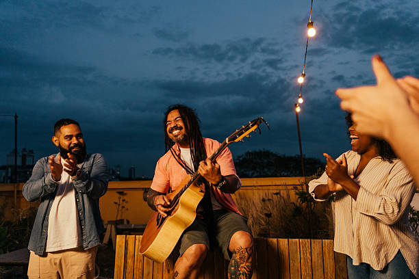 istock Man playing guitar for friends at happy hour 2240171419