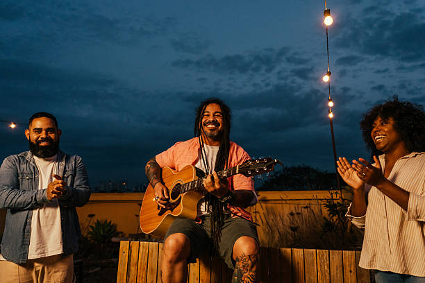 istock Man playing guitar for friends at happy hour 2240171520