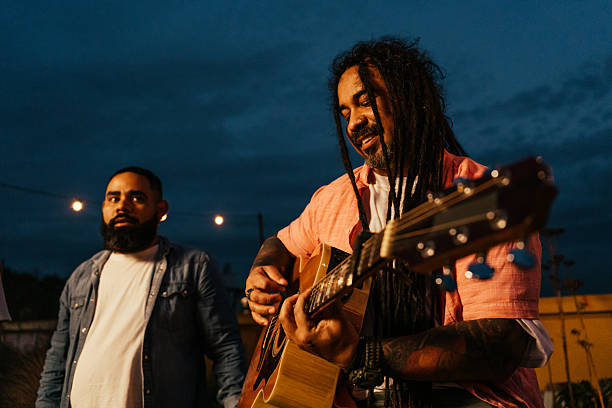 istock Man playing guitar for friends at happy hour 2240171542