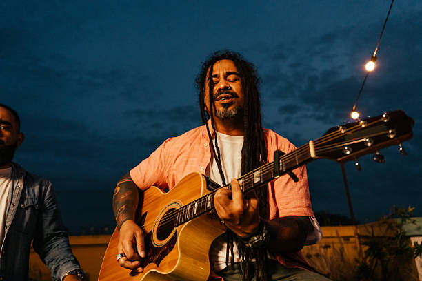 istock Man playing guitar for friends at happy hour 2240171543