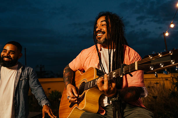 istock Man playing guitar for friends at happy hour 2240171545