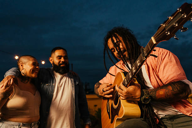 istock Man playing guitar for friends at happy hour 2240171574
