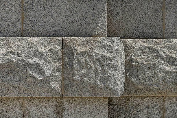 A wall of unpolished granite stones. vector stone texture background