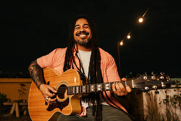 istock Man playing guitar for friends at happy hour 2240172883