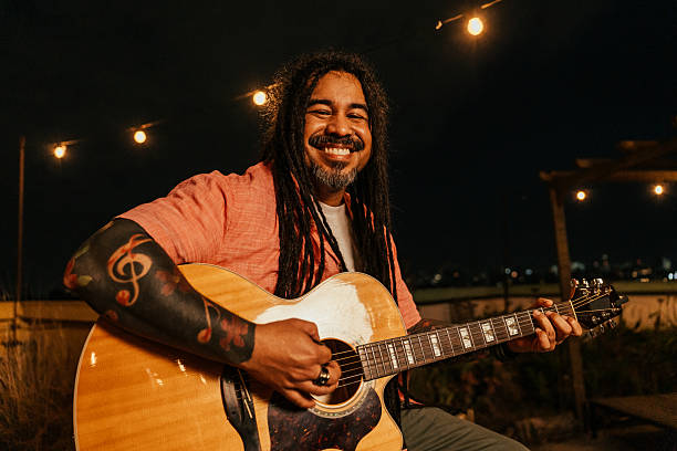 istock Man playing guitar for friends at happy hour 2240172889