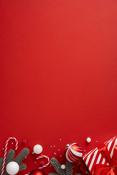 istock Vertical scene features red backdrop with candy canes pine branches ornaments and wrapped gifts conveying festive warmth and holiday anticipation for Christmas and New Year 2240173073