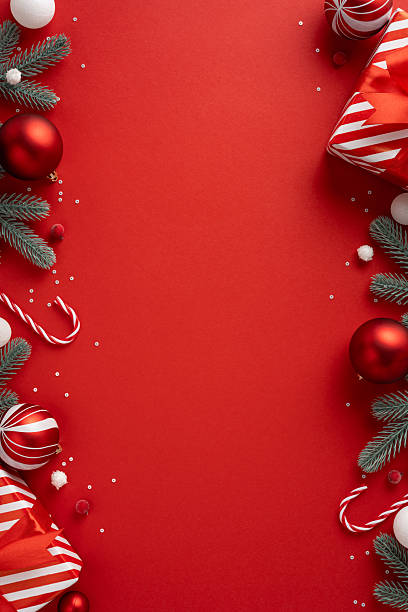 istock A vertical holiday scene features a red background framed by candy cane, gift and pine branch accents, creating a festive mood for Christmas and New Year greeting in a bright seasonal layout 2240173078