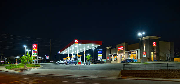 Quebec 2025-09-05: Three illuminated Petro-Canada fuel pumps, each featuring a large Canadian maple leaf motif, stand at a gas station at night, captured from a slightly low angle