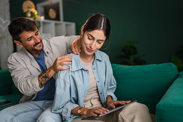 istock Partner giving relaxing neck massage to woman using tablet 2240174440