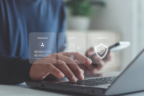 istock Businessman using laptop and smartphone with virtual login interface, showing password, MFA, security shield icons, cybersecurity, data protection, secure authentication in digital technology. 2240176268