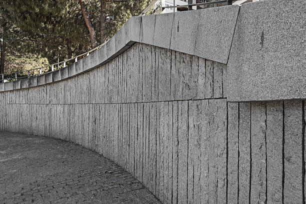 istock Gray granite wall with strips of stone and paving stone floors 2240177456