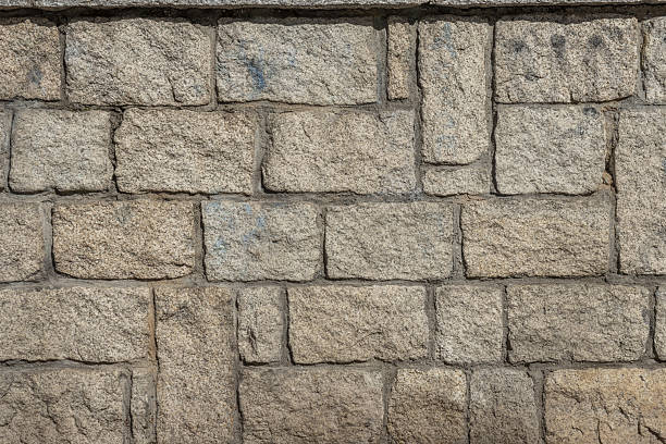 istock A wall of granite blocks with cement. vector background stone texture background 2240177457